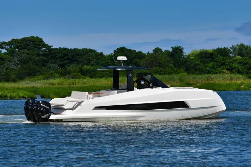  Yacht Photos Pics 2023 Astondoa 377 Coupe Outboard cruising on a serene lake with lush greenery.