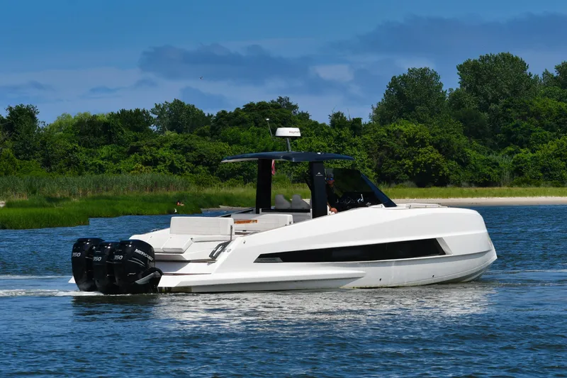  Yacht Photos Pics 2023 Astondoa 377 Coupe Outboard cruising on a serene lake with lush greenery.