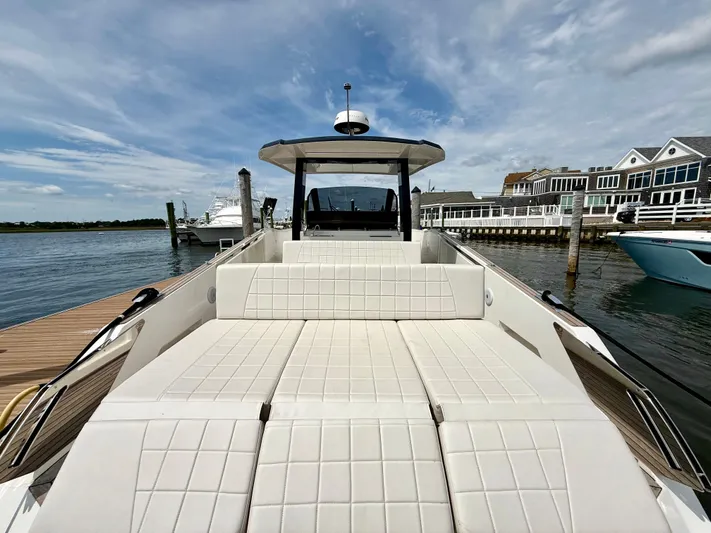  Yacht Photos Pics 2023 Astondoa 377 Coupe Outboard yacht docked, featuring spacious sunbathing area and modern design.
