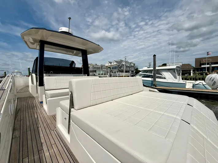  Yacht Photos Pics 2023 Astondoa 377 Coupe Outboard yacht with sleek design, docked at marina under cloudy sky.