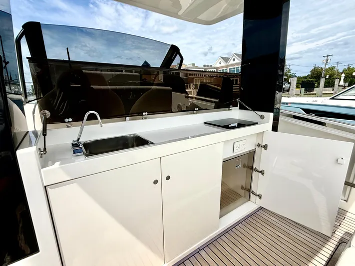  Yacht Photos Pics 2023 Astondoa 377 Coupe Outboard yacht kitchen with sink and storage.