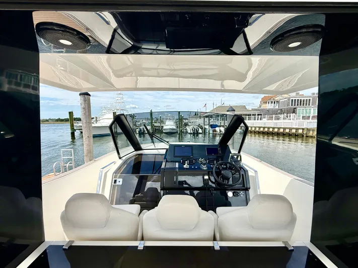  Yacht Photos Pics 2023 Astondoa 377 Coupe Outboard helm with modern controls and waterfront view.