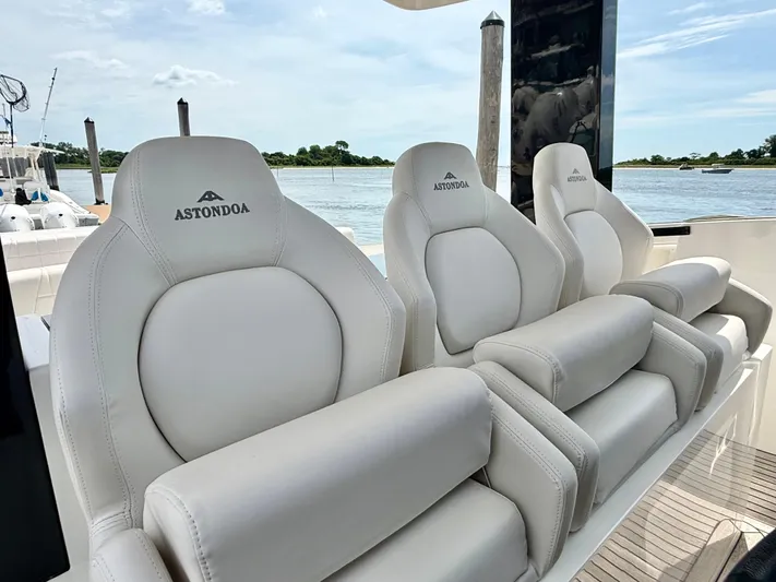  Yacht Photos Pics Luxury seating on 2023 Astondoa 377 Coupe Outboard yacht, featuring plush white upholstery.