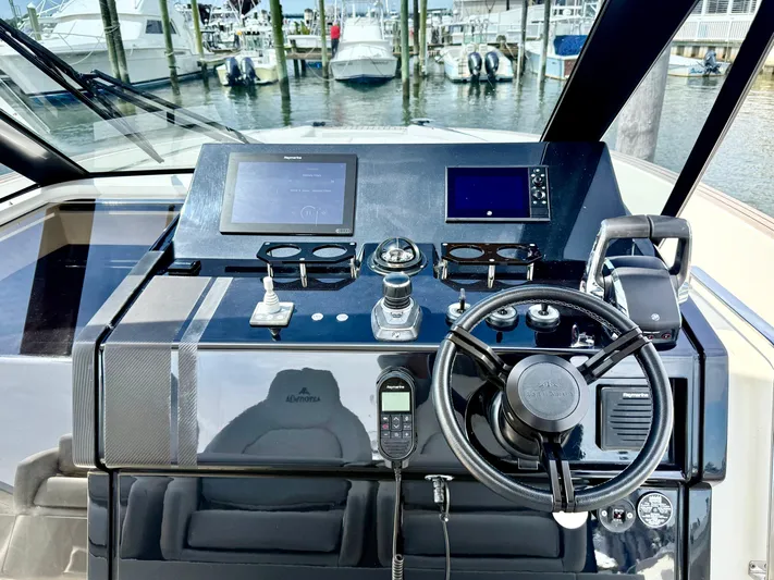  Yacht Photos Pics 2023 Astondoa 377 Coupe Outboard helm with modern controls and navigation screens.
