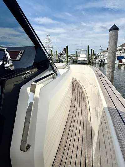  Yacht Photos Pics 2023 Astondoa 377 Coupe Outboard docked, showcasing sleek design and wooden deck.