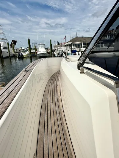 Yacht Photos Pics 2023 Astondoa 377 Coupe Outboard docked, showcasing sleek deck design and marina backdrop.