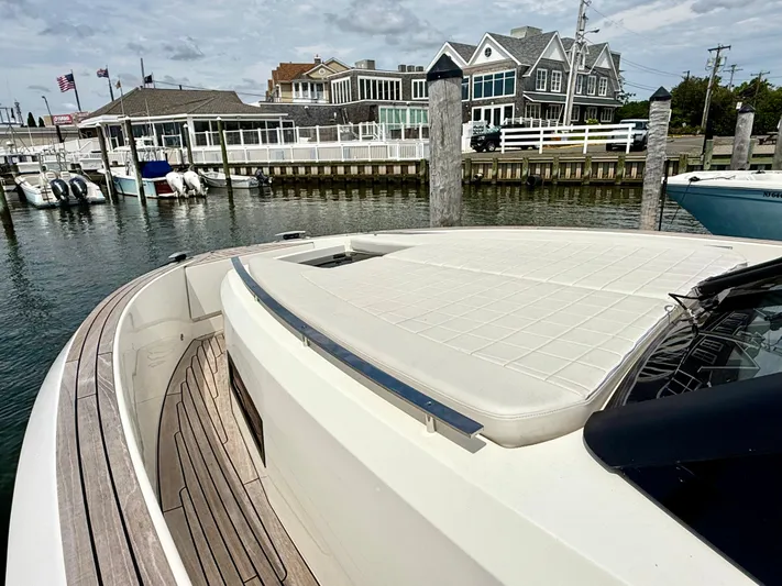  Yacht Photos Pics 2023 Astondoa 377 Coupe Outboard docked at a marina with waterfront buildings.