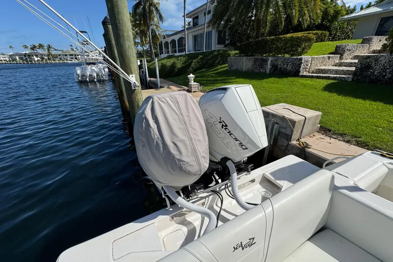  Yacht Photos Pics 2023 SeaVee 340Z boat docked, featuring powerful outboard engines, lush waterfront setting.