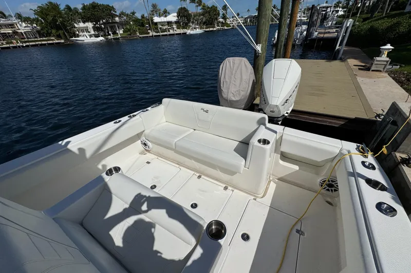 Yacht Photos Pics 2023 SeaVee 340Z boat interior with seating, docked by waterfront homes.