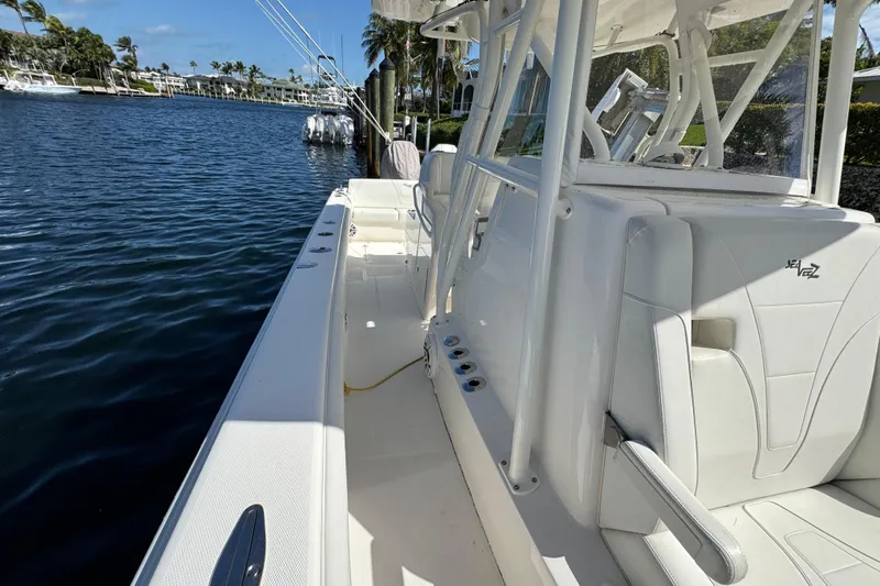  Yacht Photos Pics 2023 SeaVee 340Z boat, sleek white design, docked by a calm waterfront.