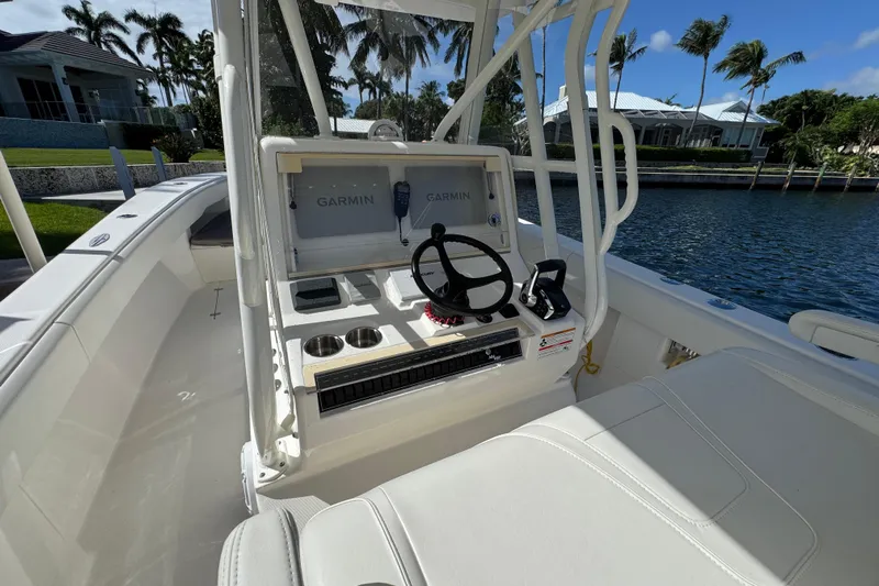  Yacht Photos Pics 2023 SeaVee 340Z boat cockpit with Garmin navigation system, steering wheel, and seating.