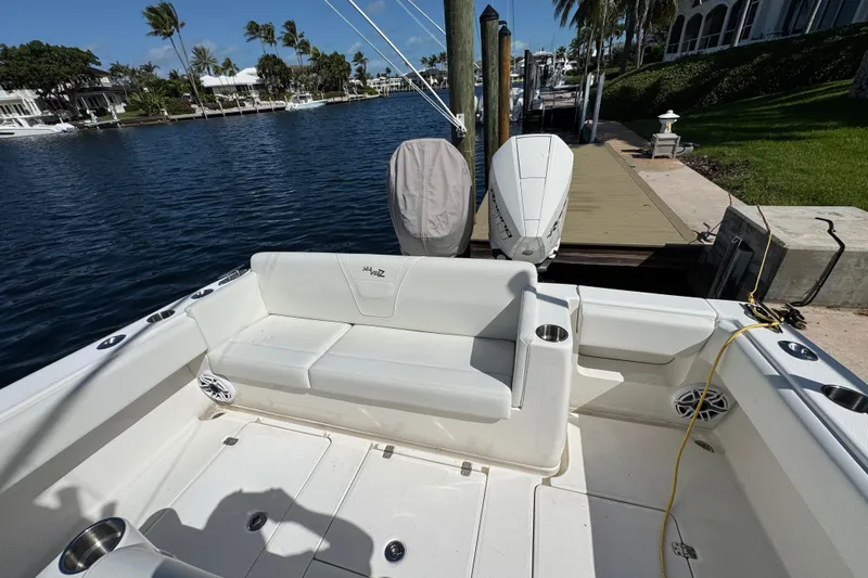  Yacht Photos Pics 2023 SeaVee 340Z boat docked, featuring spacious seating and dual outboard engines.