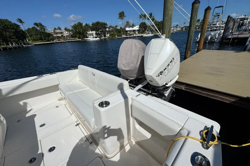  Yacht Photos Pics 2023 SeaVee 340Z boat docked, featuring spacious seating and powerful outboard engine.
