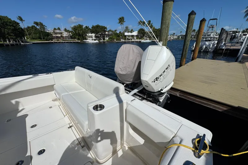  Yacht Photos Pics 2023 SeaVee 340Z boat docked, featuring spacious seating and powerful outboard engine.