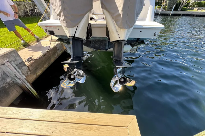  Yacht Photos Pics 2023 SeaVee 340Z boat with dual outboard motors docked by the water.