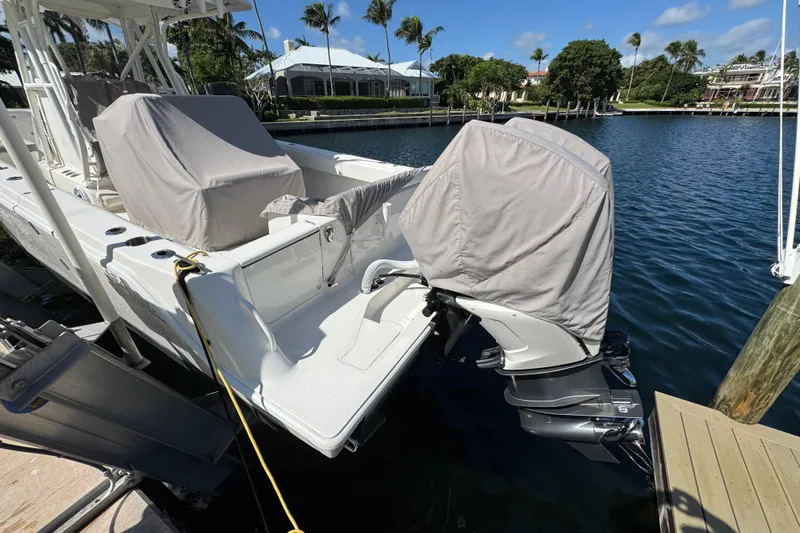  Yacht Photos Pics 2023 SeaVee 340Z boat docked with covered engines, scenic waterfront view.