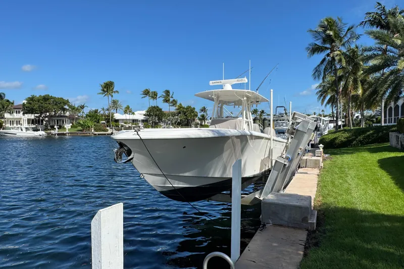  Yacht Photos Pics 2023 SeaVee 340Z boat docked by waterfront with palm trees and clear blue sky.