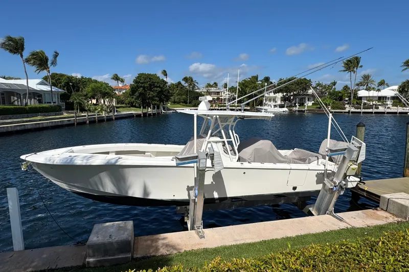  Yacht Photos Pics 2023 SeaVee 340Z boat docked by waterfront homes under clear blue sky.