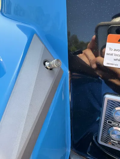  Yacht Photos Pics 2024 Malibu M242 boat detail with blue exterior and control panel.