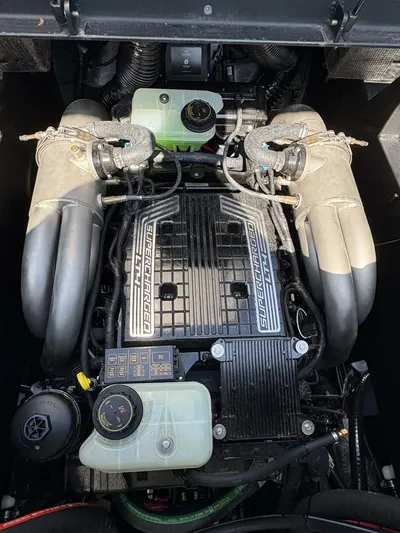  Yacht Photos Pics 2024 Malibu M242 engine compartment with supercharged engine components and fluid reservoirs.