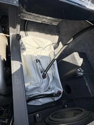  Yacht Photos Pics 2024 Malibu M242 boat interior showing ballast bag and wiring components.