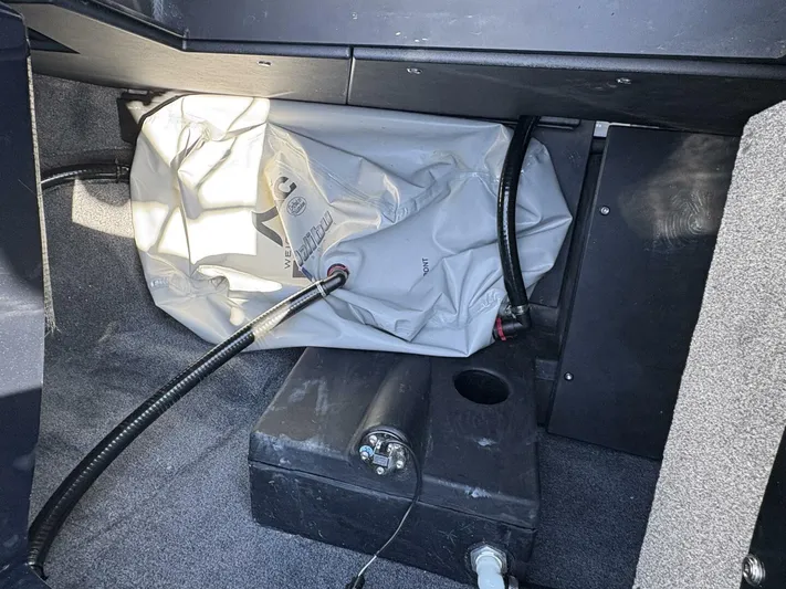  Yacht Photos Pics 2024 Malibu M242 boat interior showing ballast system components and storage area.