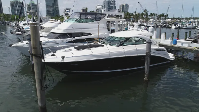 Cay IV Yacht Photos Pics 2013 Sea Ray 410 Sundancer yacht docked in a marina with other boats.