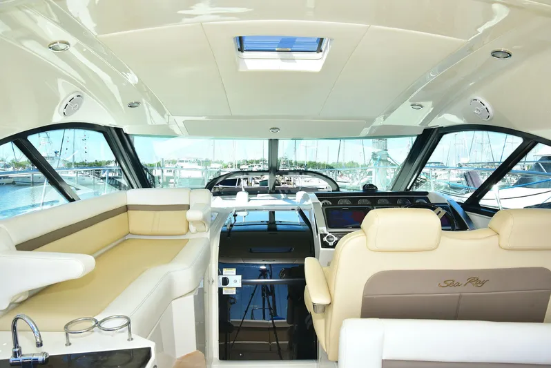 Cay IV Yacht Photos Pics Interior of 2013 Sea Ray 410 Sundancer yacht with luxurious seating and helm.