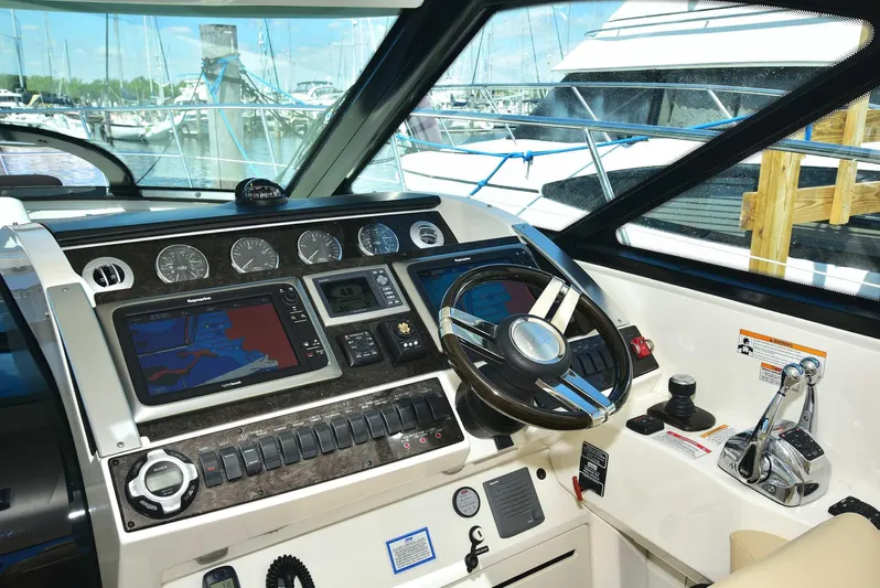 Cay IV Yacht Photos Pics Helm of 2013 Sea Ray 410 Sundancer with navigation controls and steering wheel.