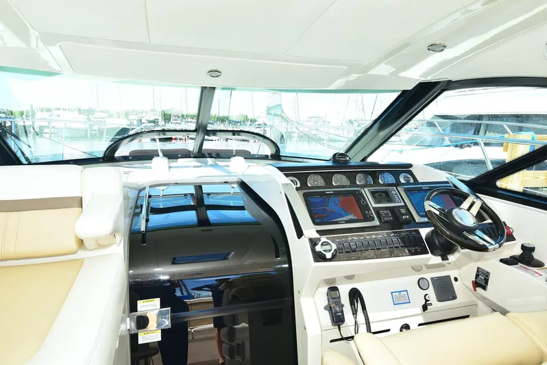 Cay IV Yacht Photos Pics Cockpit of 2013 Sea Ray 410 Sundancer with modern navigation controls and steering wheel.