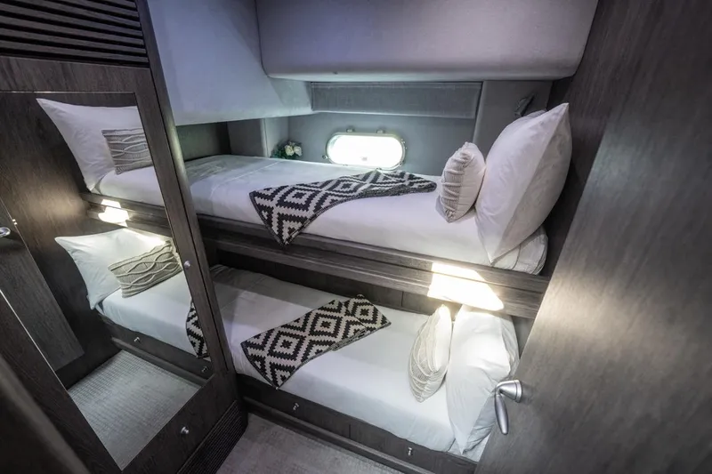 The Matrix Yacht Photos Pics Luxurious twin bunk cabin in 2007 Sunseeker 82 Yacht, featuring modern decor and cozy bedding.