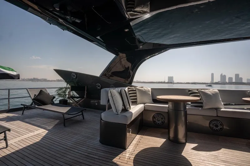 The Matrix Yacht Photos Pics Luxurious 2007 Sunseeker 82 Yacht deck with seating, overlooking city skyline and water.