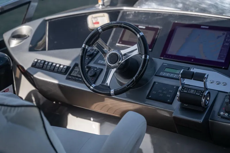 The Matrix Yacht Photos Pics Cockpit of 2007 Sunseeker 82 Yacht with steering wheel and navigation controls.