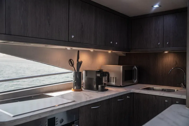 The Matrix Yacht Photos Pics Luxurious kitchen interior of 2007 Sunseeker 82 Yacht with modern appliances and sleek design.