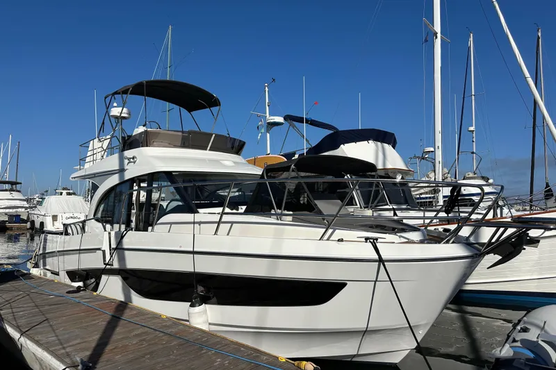 Vitamin Sea Yacht Photos Pics 2023 Beneteau Antares 11 Fly yacht docked at marina under clear blue sky.