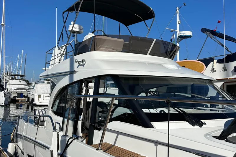 Vitamin Sea Yacht Photos Pics 2023 Beneteau Antares 11 Fly yacht docked at marina under clear blue sky.