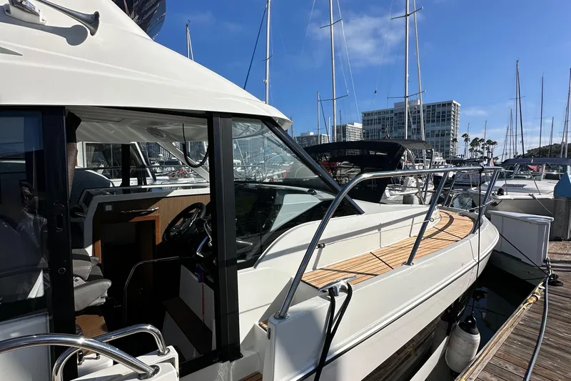 Vitamin Sea Yacht Photos Pics 2023 Beneteau Antares 11 Fly yacht docked at marina, showcasing sleek design and modern features.