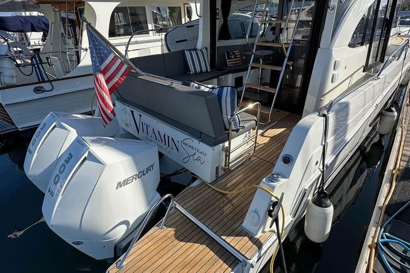Vitamin Sea Yacht Photos Pics 2023 Beneteau Antares 11 Fly with Mercury engines, docked with American flag.