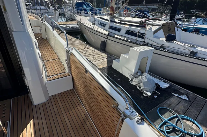 Vitamin Sea Yacht Photos Pics 2023 Beneteau Antares 11 Fly yacht docked, showcasing sleek deck design and marina surroundings.