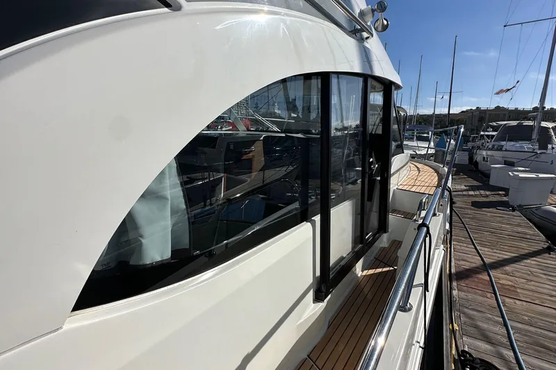 Vitamin Sea Yacht Photos Pics 2023 Beneteau Antares 11 Fly yacht docked, showcasing sleek design and modern features.