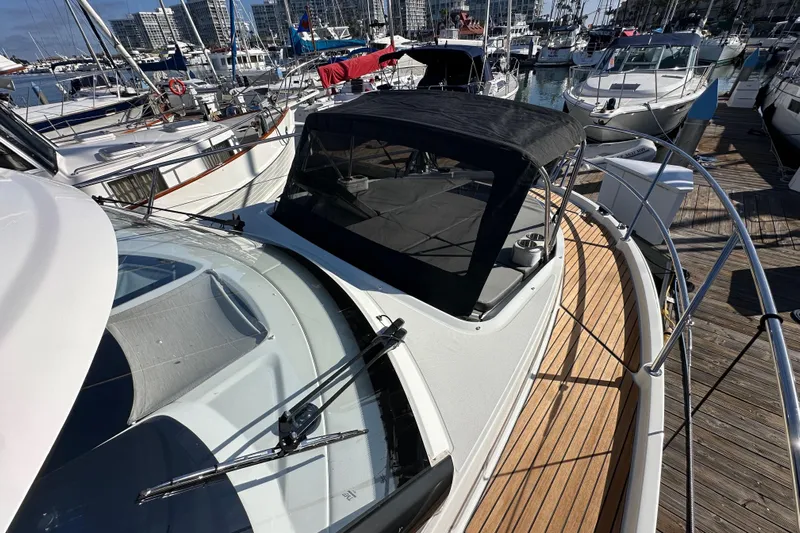 Vitamin Sea Yacht Photos Pics 2023 Beneteau Antares 11 Fly yacht docked at marina, showcasing sleek design and wooden deck.