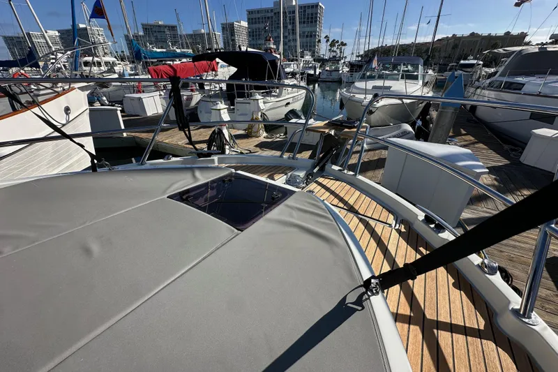 Vitamin Sea Yacht Photos Pics 2023 Beneteau Antares 11 Fly yacht docked at marina with other boats.