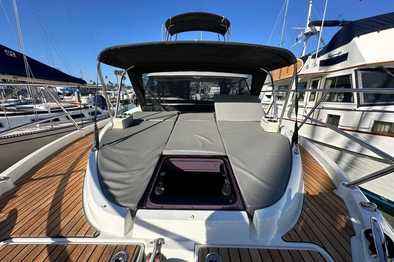 Vitamin Sea Yacht Photos Pics 2023 Beneteau Antares 11 Fly yacht with sun deck, docked in marina.