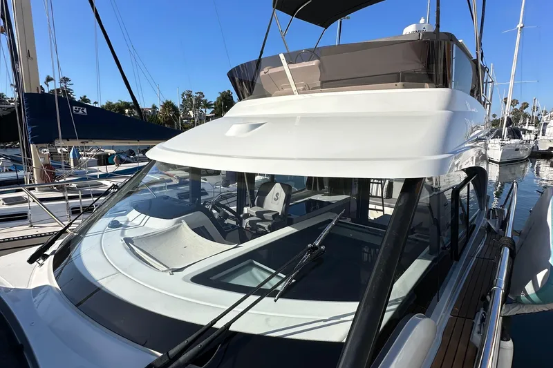 Vitamin Sea Yacht Photos Pics 2023 Beneteau Antares 11 Fly yacht docked at marina, showcasing sleek design and flybridge.