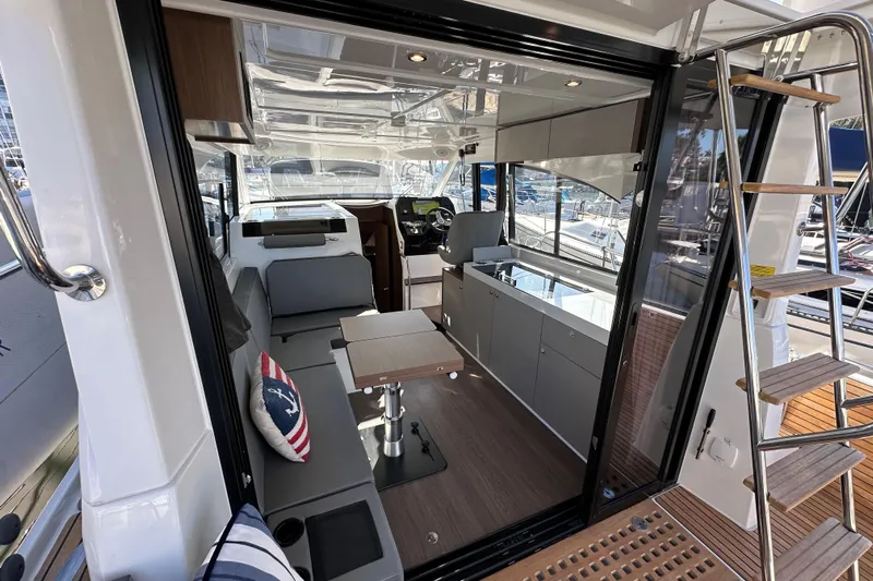 Vitamin Sea Yacht Photos Pics Interior view of 2023 Beneteau Antares 11 Fly yacht, featuring modern seating and helm.