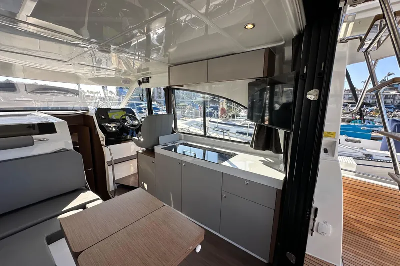 Vitamin Sea Yacht Photos Pics Interior of 2023 Beneteau Antares 11 Fly, featuring modern helm and seating area.