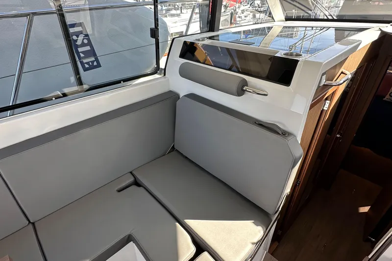 Vitamin Sea Yacht Photos Pics Interior seating area of 2023 Beneteau Antares 11 Fly, featuring modern design and comfortable cushions.