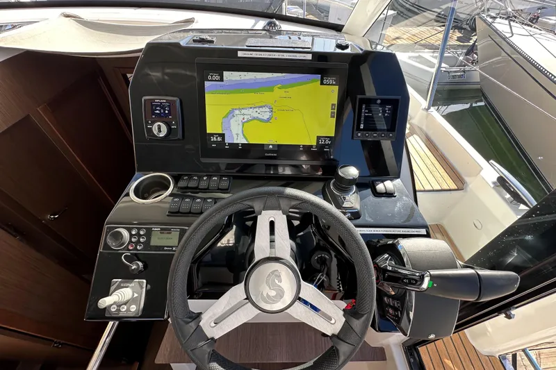 Vitamin Sea Yacht Photos Pics Cockpit of 2023 Beneteau Antares 11 Fly with navigation controls and display.