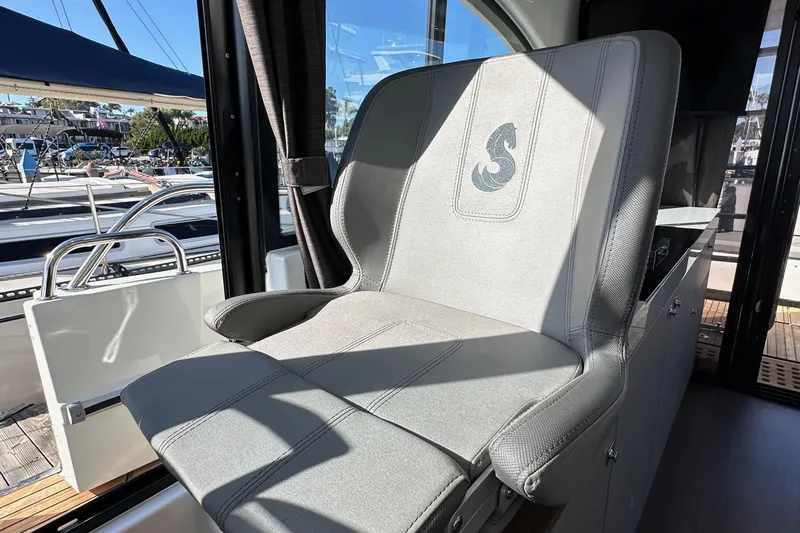 Vitamin Sea Yacht Photos Pics Captain's seat on 2023 Beneteau Antares 11 Fly, featuring sleek design and comfort.