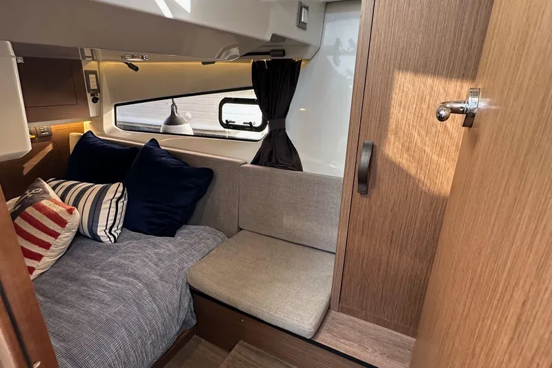 Vitamin Sea Yacht Photos Pics 2023 Beneteau Antares 11 Fly cabin interior with cozy seating and nautical decor.